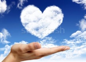 828729_stock-photo-hand-holding-heart-shape-cloud-and-blue-sky