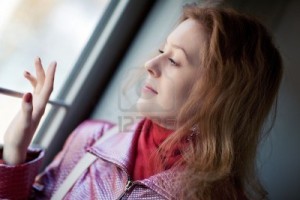 5781512-young-woman-looking-to-the-train-window-portrait