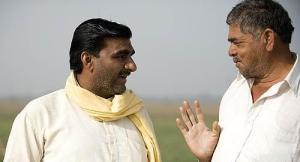 two indian villagers talk on the roadside , india