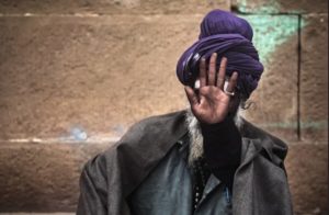 man hiding his face