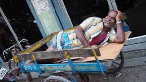 man lying in vehicle