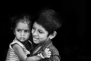 Brother and sister in hug with love and big happy smile